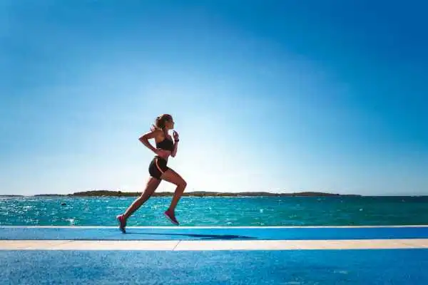 Woman running showing strong leg muscle Atherstone